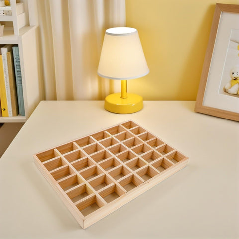 Top Tier Solid Wood Jewelry Tray Organizer Designed To Keep Your Bling Neatly Arranged In 36 Grids On a table with lamp.