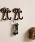 Straight Up Legit Mushroom Wall Hooks Set Of Two Heavy Duty Cast Iron Coat Hangers With Antique Black Finish hanging keys on wall.