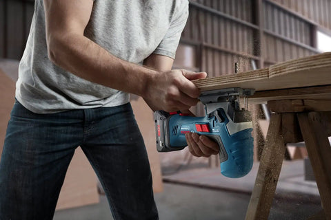 User operating Real Deal 18V Cordless Jigsaw Packing on plywood, showcasing quick swap blades and dust extraction.