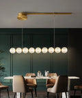 Modern Minimalist 9 Light Brass Magnetic Bean Pendant Lamp Sculptural Chandelier For Cafe Bar Home Decor Durable Build Smooth Even Glow Fresh Vibe Easy Install above a dining table in a stylish green room