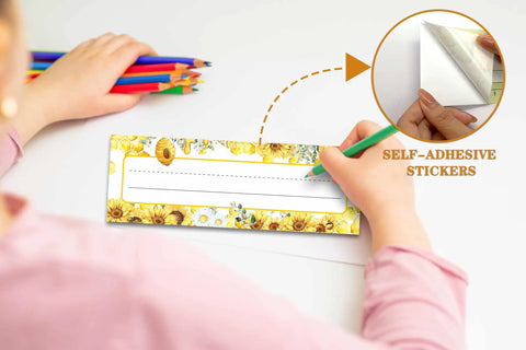 Child writing on 30 Classroom Name Tags Set With Sunflower Desk Tags And Bumble Bee Labels, self-adhesive, durable 3x9 inch plates