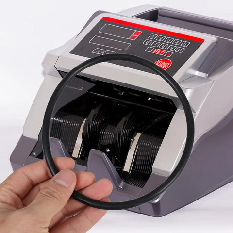 Hand holding currency counter belt replacement part for cash counting machines with 13.2 cm outer diameter and 6 mm thickness.