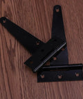 Heavy Duty Iron T Shape Door Hinges, 4 Inch Black, 24 Pieces, 6 Screw Holes, Flexible Silent Gate Hinges on wooden surface