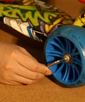 Hand using Allen key from Must-Have All-In-One 198 Piece Home Repair Tool Kit With Plastic Toolbox for DIY projects on scooter wheel