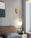 Bedroom setting with Brushed Gold Modern Wall Sconces Set Of Two With Milky White Hanging Globe Glass Shade Indoor Wall Lighting.