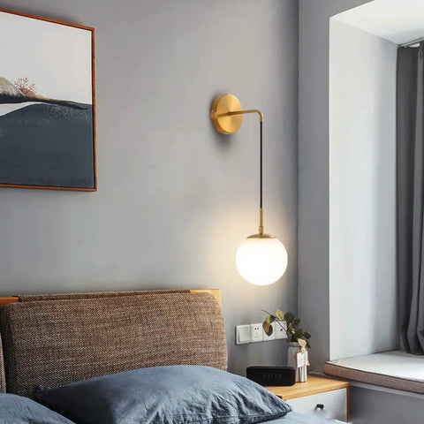 Bedroom setting with Brushed Gold Modern Wall Sconces Set Of Two With Milky White Hanging Globe Glass Shade Indoor Wall Lighting.