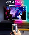 Person using remote to control LED Lights For Bedroom 50 Feet RGB Color Changing Strip Kit with display showing vibrant colors.