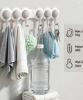 Heavy Duty Six Hook Adhesive Wall Rack With Smooth 180 Degree Swivel And Easy No Drill Mount holding towels and keys.