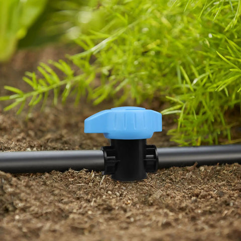 Five Pack Half Inch Drip Irrigation Shut Off Valves Inline Barbed Cut Off Valves For Garden Irrigation System Fits Half Inch Tubing 570 To 620 ID Durable One Piece Construction shown in garden setting with greenery