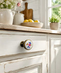 Vintage Floral Ceramic Cabinet Knobs And Drawer Pulls Featuring Dual Mounting Screws For A Super Easy Kitchen Cupboard Or Dresser Hardware Swap That Brings Chill Vibes on a white cabinet.