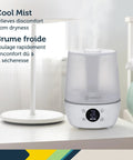 Filter Free Humidifier With Auto Humidity Control And Hygrometer on a bedside table in a white finish with digital display.