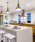 Modern kitchen with island, pendant lights, and wooden cabinets showcasing elegant dining setup