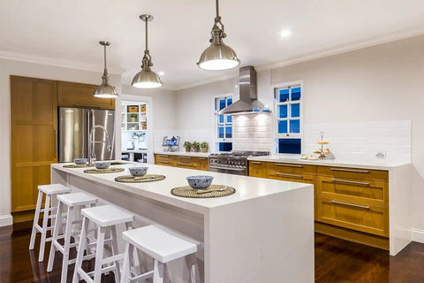 Modern kitchen with island, pendant lights, and wooden cabinets showcasing elegant dining setup