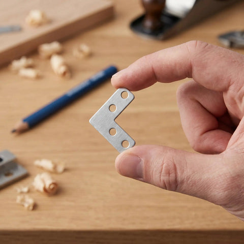 Person holding a Heavy Duty Stainless Steel L Bracket Corner Brace 1.6x1.6 Inch Right Angle Support Connector