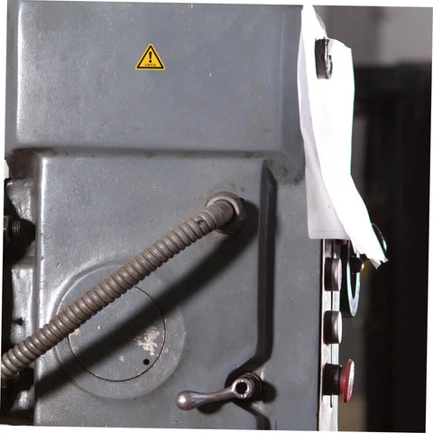 Close-up of equipment with a 24 Pcs Machine Warning Labels Safety Sign Stickers Caution Decals For Equipment Factory Indoor Outdoor Use