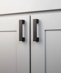 10 Pack Matte Black Kitchen Cabinet Handles Low Profile Drawer Pulls on white doors, showcasing modern square design and durable construction