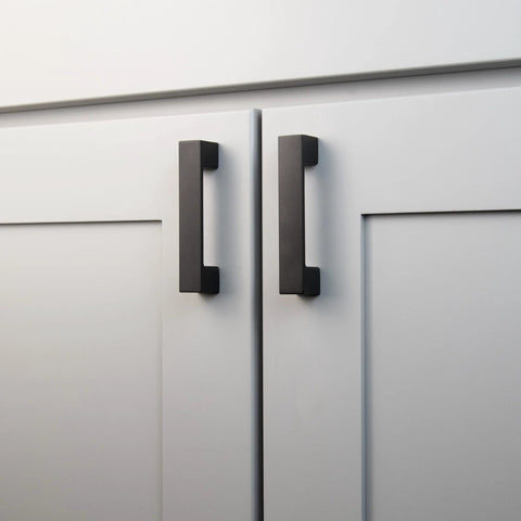 10 Pack Matte Black Kitchen Cabinet Handles Low Profile Drawer Pulls on white doors, showcasing modern square design and durable construction