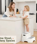 Toddler using Rock Solid Two Step Stool for easy access to kitchen counter, gray non-slip design, light weight, perfect for daily chores.