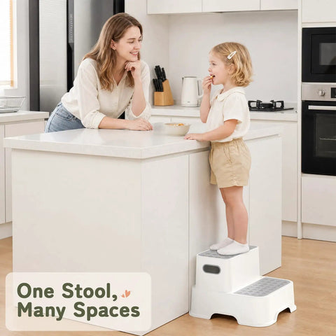 Toddler using Rock Solid Two Step Stool for easy access to kitchen counter, gray non-slip design, light weight, perfect for daily chores.