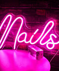 Pink Neon Sign LED Wall Light For Nail Salon And Beauty Room Decor USB Powered glowing pink 'Nails' sign against brick wall