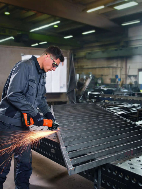 Person using Compact 18V Brushless Cordless Angle Grinder With 125 MM Disc and Rock Solid Dust Resistant Design for cutting metal.