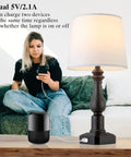 Rustic 3 Way Touch Control Table Lamps Set Of 2 With Dual USB Ports next to a person using a USB device.