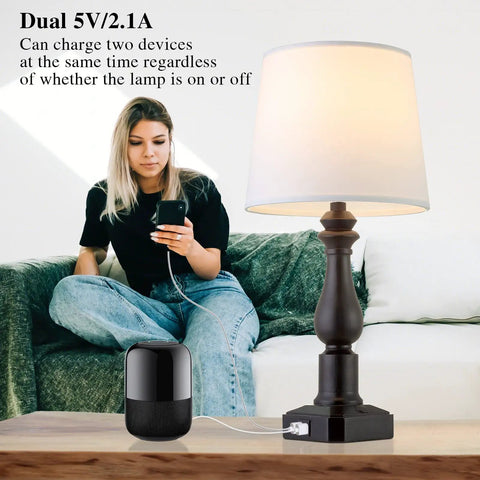 Rustic 3 Way Touch Control Table Lamps Set Of 2 With Dual USB Ports next to a person using a USB device.