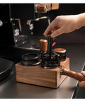 Premium Walnut Espresso Tamper Station With Integrated Powder Scaler And Crumb Bin Universal Portafilter Rest for brewing on countertop.