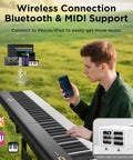 Man playing 88 Key Magnetic Split Piano Keyboard, Detachable Travel Electric Piano For Beginners in a field, using wireless connection.