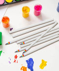 Rainbow Paper Pencils Set 24 Pieces Number 2 HB Graphite Pencils With White Barrels and colorful tips on art supplies table