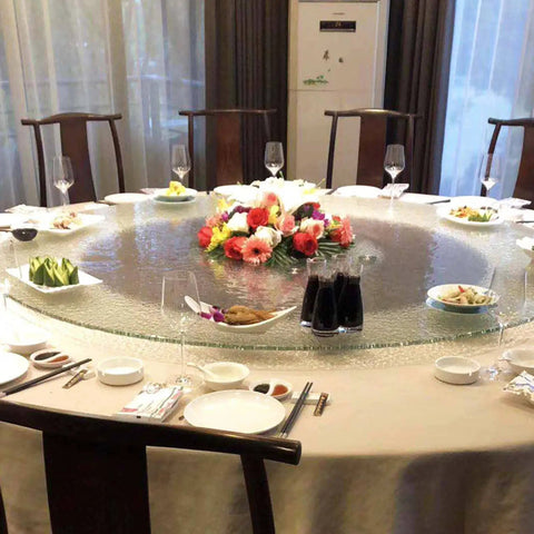 Elegant dining setup with 31 Inch To 35 Inch Tempered Glass Lazy Susan Turntable, floral centerpiece, plates, and glasses
