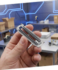 Hand holding Automatic Tape Cutter Baffle Plate Replacement For Tape Dispensers Universal Compatibility Spare Part For Packaging And Shipping Tasks Easy Install Reduces Manual Adjustments And Downtime Craft And Shipping Tape Ready