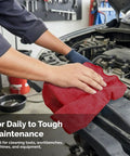 Hand using Heavy Duty Cotton Shop Towels Red Pack Of 150 Absorbent Cleaning Rags For Auto Garage And Home Multipurpose Towels