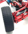 Level Up Your Bash Truck Setup With These Built Tough Aluminum Steering Blocks And Rear Wheel Hubs Crafted To Deliver Superior Grip As Direct Fit Replacement For 144016 144018 Rc Crawlers In Bright Yellow Finish. Close-up of RC truck tire and red aluminum components.