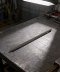 Durable Manual PVC Wire Tube Spring Bender Tool For Smooth Pipe Bending On 16Mm To 32Mm Conduit on a workbench surface.