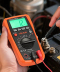 Person using All In One Digital Multimeter With 4000 Count TRMS Readouts For DC And AC Voltage And Current on car battery