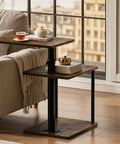 C Shaped End Table With 360 Degree Swivel Height Adjustable Sofa Side Table With Storage Open Shelf 3 Tier Night Stand TV Tray For Small Spaces Rustic Brown Living Room Bedroom beside a sofa by a window with tea and books on the table.