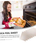 Woman placing dish in oven, showcasing 10 Piece Mica Plates 150x120mm Microwave Heat Insulation And Fireproof Sheets for kitchen use.