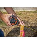 Three Eighths Inch By Fifty Foot Steel Construction Long Tape Measure With Three To One Gear used at a construction site