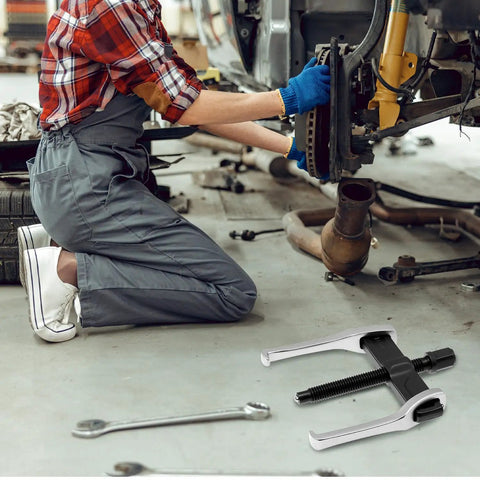 Mechanic using 4 Inch 2 Jaw Gear Puller For Internal And External Removal Of Flywheels Gears Pulleys And Bearings Built Tough In CRV Steel With Reversible Jaws