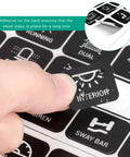 Close-up of 120 Piece Car Switch Panel Sticker Kit with Durable PVC Decals for auto console buttons being applied by hand.