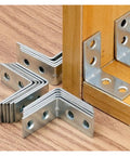 Beefy L Shaped Corner Brackets For Shelves Heavy Duty Metal Wall Mount Supports stacked on wooden surface next to mounted bracket