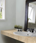 Bathroom countertop with Beige Marble Self-Adhesive Film Roll 17x78 Inches, 2 Pack, installed, near sink with mirror and window.