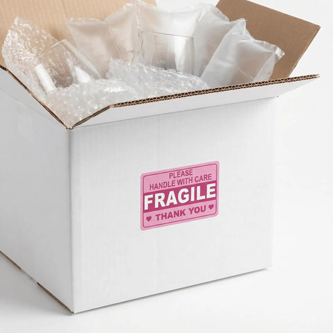 Fragile Shipping Labels Pack With Red Copper Plate Stickers For Quick ID And Clear Communication, Rectangle And Round Shapes For Courier Ops And Packing Supplies, Handle With Care. White box with pink fragile shipping label.