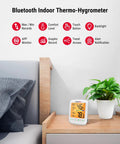 Bluetooth Hygrometer Thermometer With Large Backlit LCD, Indoor Temperature And Humidity Monitor, Ultra Accurate NTC Sensor, Remote Reading Up To 260 Feet, Simple App Sync on bedside table