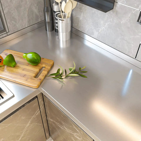 Kitchen countertop with Stainless Steel Look Peel And Stick Contact Paper Silver Vinyl Wrap, cutting board, and kitchen items.