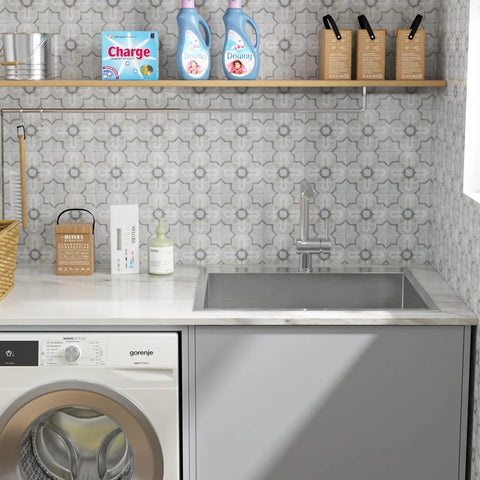 Drop-in stainless steel laundry sink, single bowl, 25x22 inches, 12-in deep, mounted over a washer in a gray-cabinet laundry room.