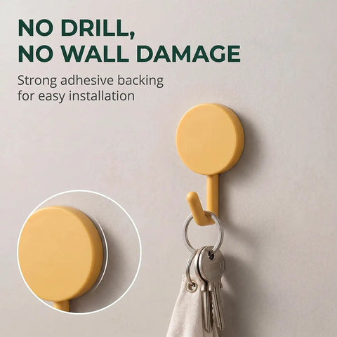 15 Pack Self Adhesive Wall Hooks With Hella Strong Grip No Drilling Damage Free Mounting For Towels Keys And Flatware Decorative Cutesy Style featuring yellow adhesive hook mounted on wall.