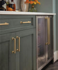 Cabinet with Lintel 18 Inch Center To Center Champagne Bronze Appliance Pull For Paneled Appliances And Large Cabinets Transitional Style Heavy Wide Profile Overall Length 19 1 4 Inches BP37450CZ installed on green wood panel doors
