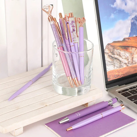 9 Piece Ballpoint Pen Set With Metal Crystal Diamond Glitter Ink For Journaling Purple Pens For Home Office Desk Dope Stationery Gift For Women And Girls displayed in a glass cup next to a laptop.
